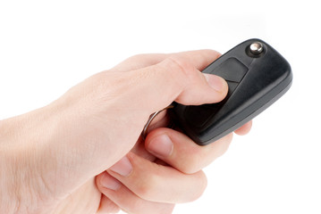 Hand holding car keys isolated on white background