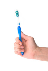toothbrush in hand on background.