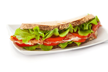 Sandwich with ham, tomatoes and salad