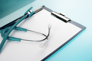 Stethoscope and empty document in a clipboard