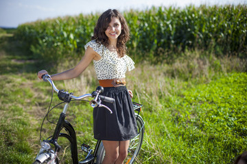 Fototapeta na wymiar Pretty girl with bike