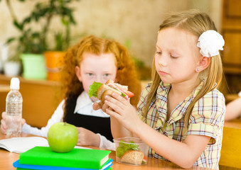 Group of classmates having lunch during break 