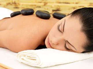Obraz na płótnie Canvas Stone massage for woman at spa salon.