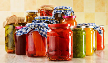 Composition with jars of pickled vegetables. Marinated food
