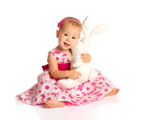 little baby girl hugging a  toy bunny rabbit isolated on white