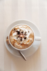 cup of tasty coffee on white empty table