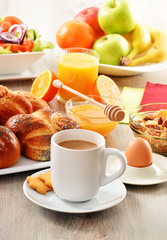 Breakfast including coffee, bread, honey, orange juice, muesli a