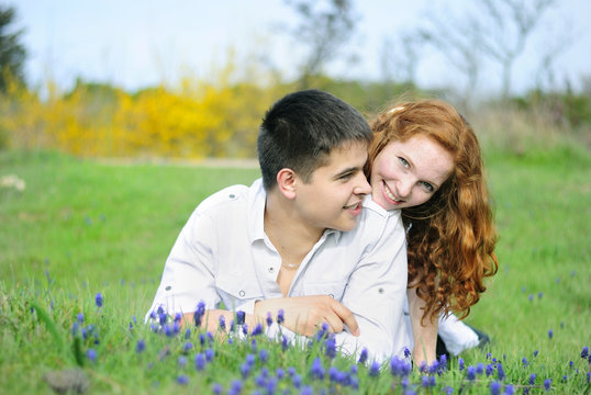 beautiful young couple in love on a green glade