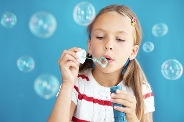 Child blowing soap bubbles