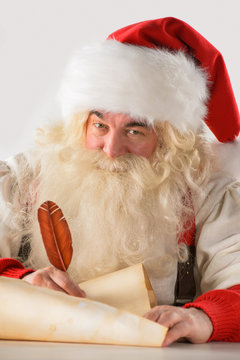 Real Santa Claus writing list of gifts or responding to children