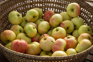 Woven basket full of green and red apples