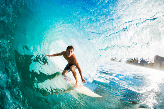 Surfer on Blue Ocean Wave in the Tube Getting Barreled