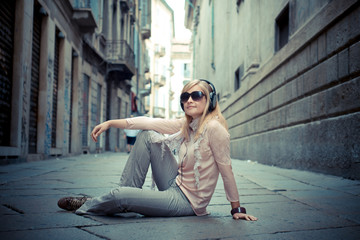 beautiful blonde woman listening to music