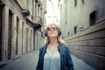 beautiful blonde woman listening to music