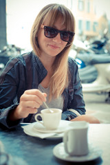 beautiful blonde woman having breakfast at the bar