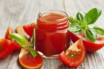 Fresh tomato sauce with basil on wooden table