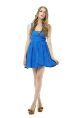 Full body young woman in blue dress. Posing Isolated