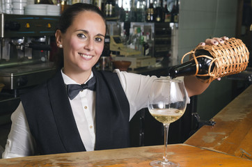 Waitress serving white wine