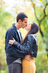 Fototapeta premium couple kissing outdoor in the park
