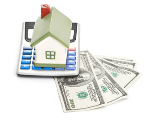 house sitting with a calculator and dollar