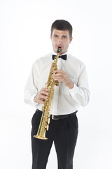 Fototapeta premium Young handsome man plays saxophone