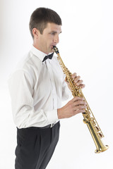 Fototapeta premium Young handsome man plays saxophone