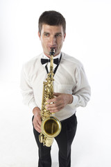Obraz premium Young handsome man plays saxophone