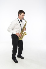 Handsome man plays saxophone