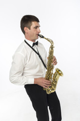 Obraz premium Young handsome man plays saxophone