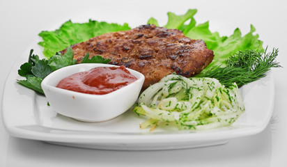 Grilled steak on a white plate