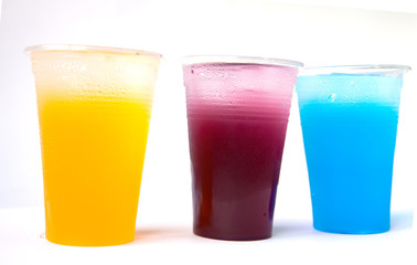 Colorful sweet fruit juice in plastic glass