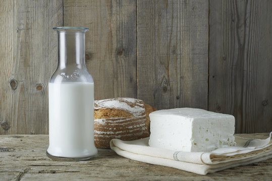 Fresh feta cheese with bottle of milk and bread