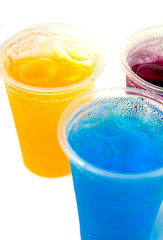 Colorful sweet fruit juice in plastic glass