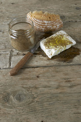 Fresh feta cheese full of olive oil, oregano vase and a bread