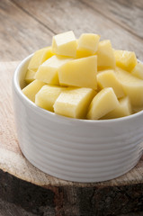 cut raw potatoes in bowl