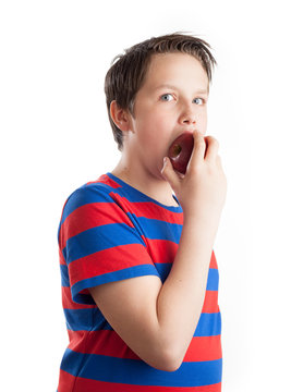 Teenager eating red apple