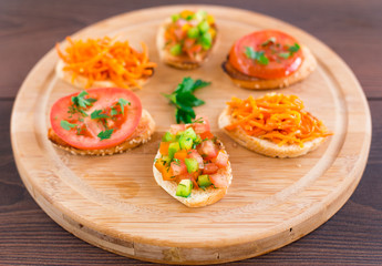 Delicious bruschetta with vegetables and herbs