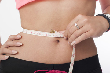 girl measures the waist with meter