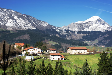 village in Aramaio valley, with snowy mountains. Basque Country.