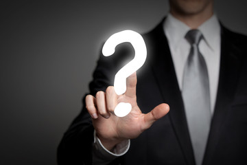 businessman pressing touchscreen questionmark - question