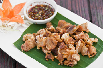 Deep fried crispy pork with spicy sauce.