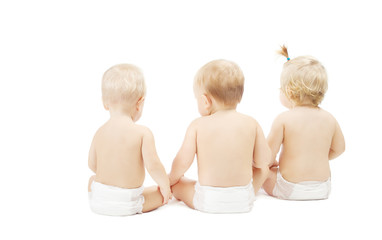 Baby in diapers sitting back side, white background
