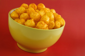 Cheese and chili flavored snack balls on bowl