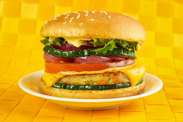 Vegetarian burger on plate , yellow background