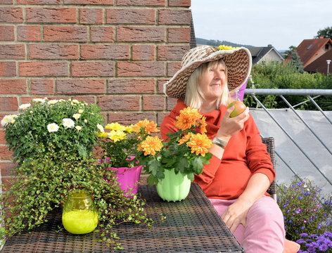 Frau im Sp&auml;tsommer mit herbstlichen Blumen