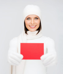 woman in winter clothes with blank red card