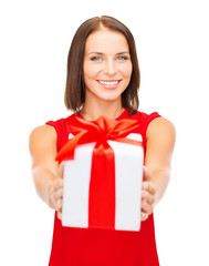 smiling woman in red dress with gift box