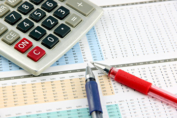 Pen and Calculator that is placed on businesses graph.