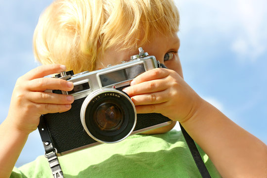 Child Taking Picture with Vintage Camera