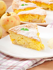 Slice of apple fruit pie on a plate decorated with mint leaf
